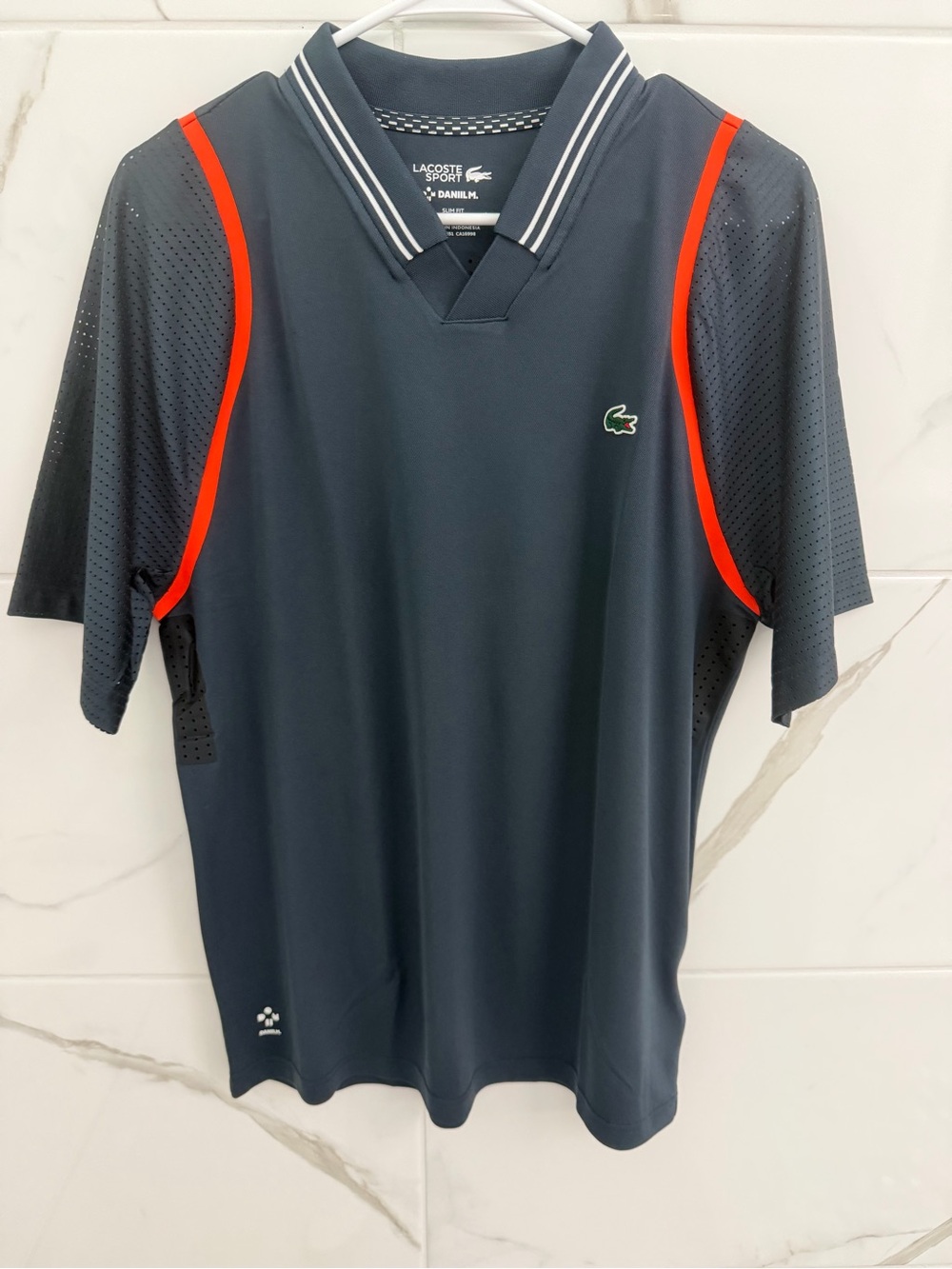 Lacoste Sport Men’s Dark Navy Performance Polo with orange Accents